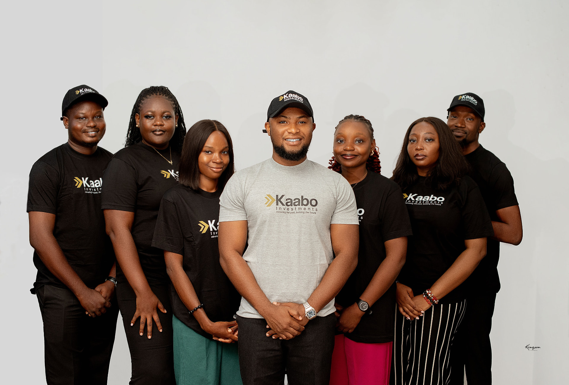 The Kaabo Investments Limited team in branded shirts and caps, Abuja